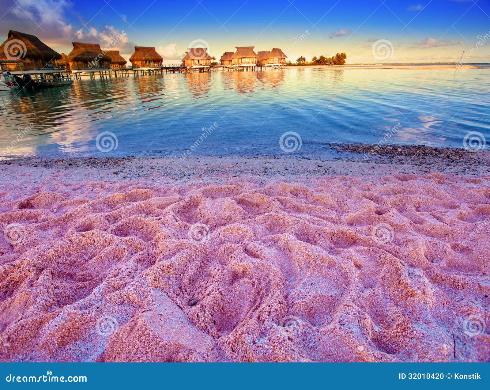 Beach With Pink Sand And Lodges On Water Stock Photo ...