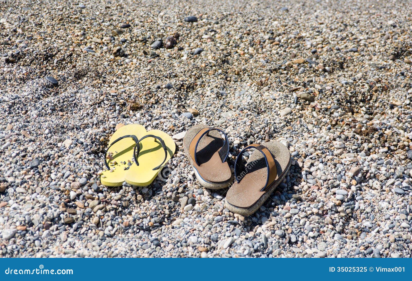 Beach Shoes at the Edge of the Sea on the Sandy Beach. Stock Image
