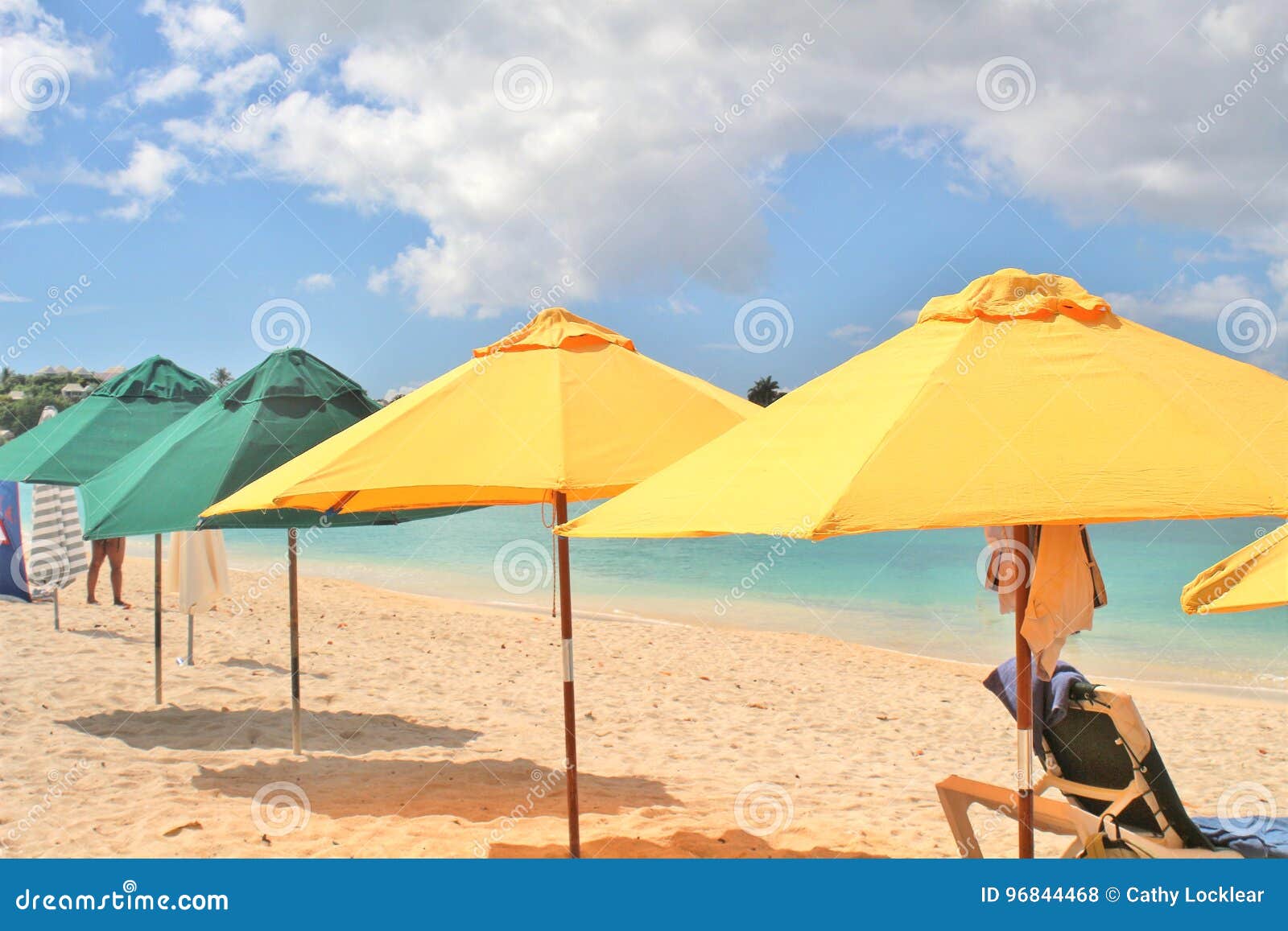 Beach Umbrellas Set Up in the Sand, Along the Shore Stock Photo Image