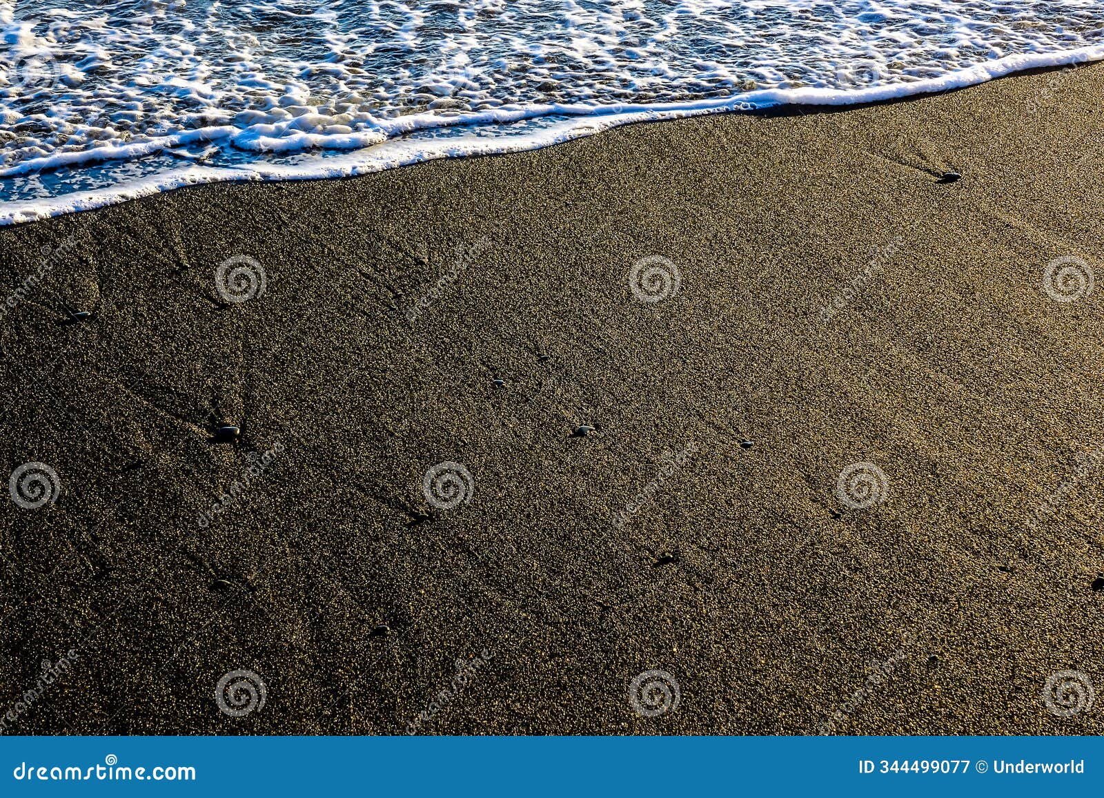 a beach with a wave crashing into the shore