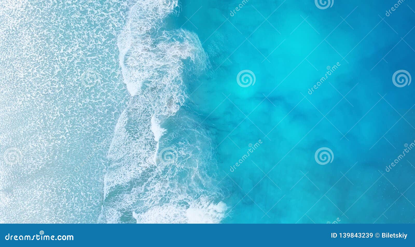 beach and waves from top view. turquoise water background from top view. summer seascape from air.