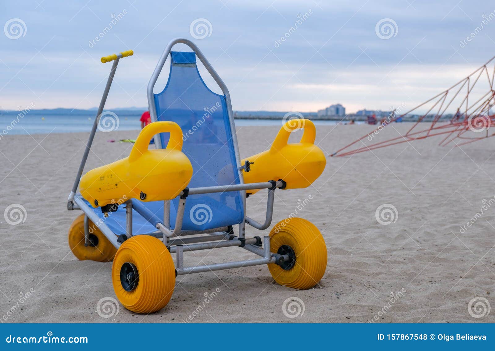 Beach Wheel Chair for Disabled Swimmers in the Beach on Blue Sea