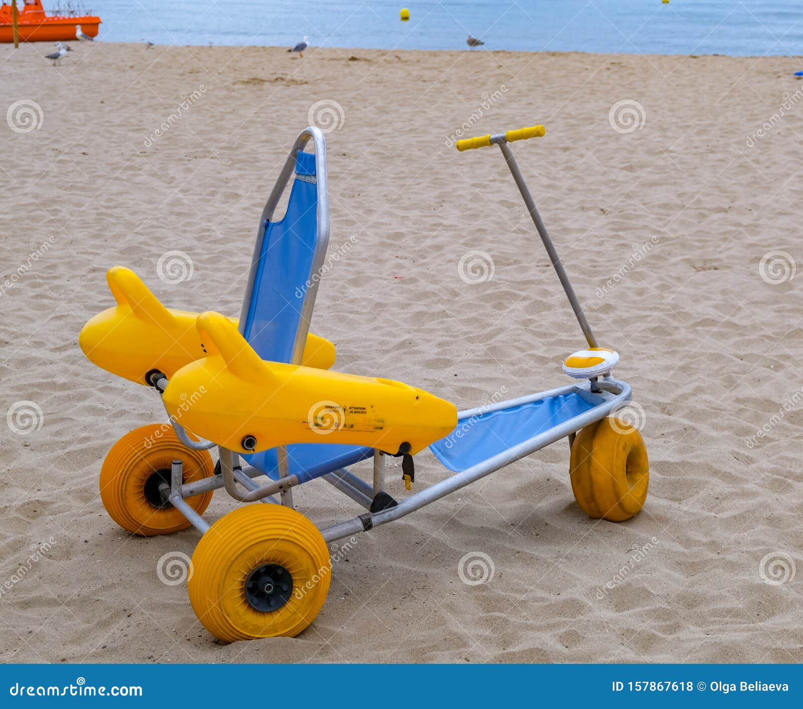 Beach Wheel Chair for Disabled Swimmers in the Sandy Beach on Sea