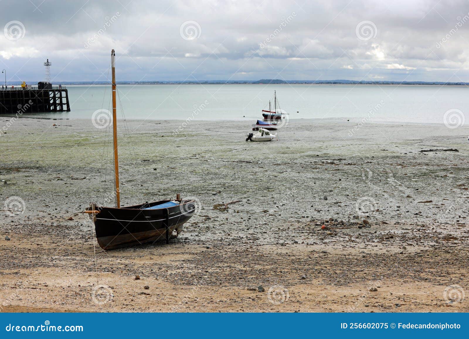 beached boats on the seabed during low tide in cancale village in france