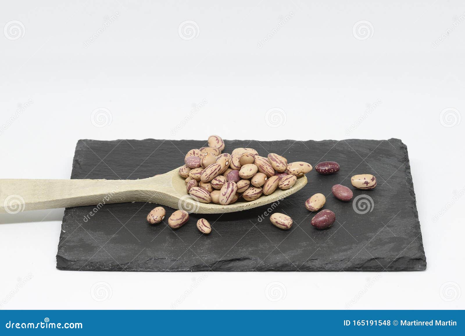 bean pint or bean with wooden spoon on slate plate