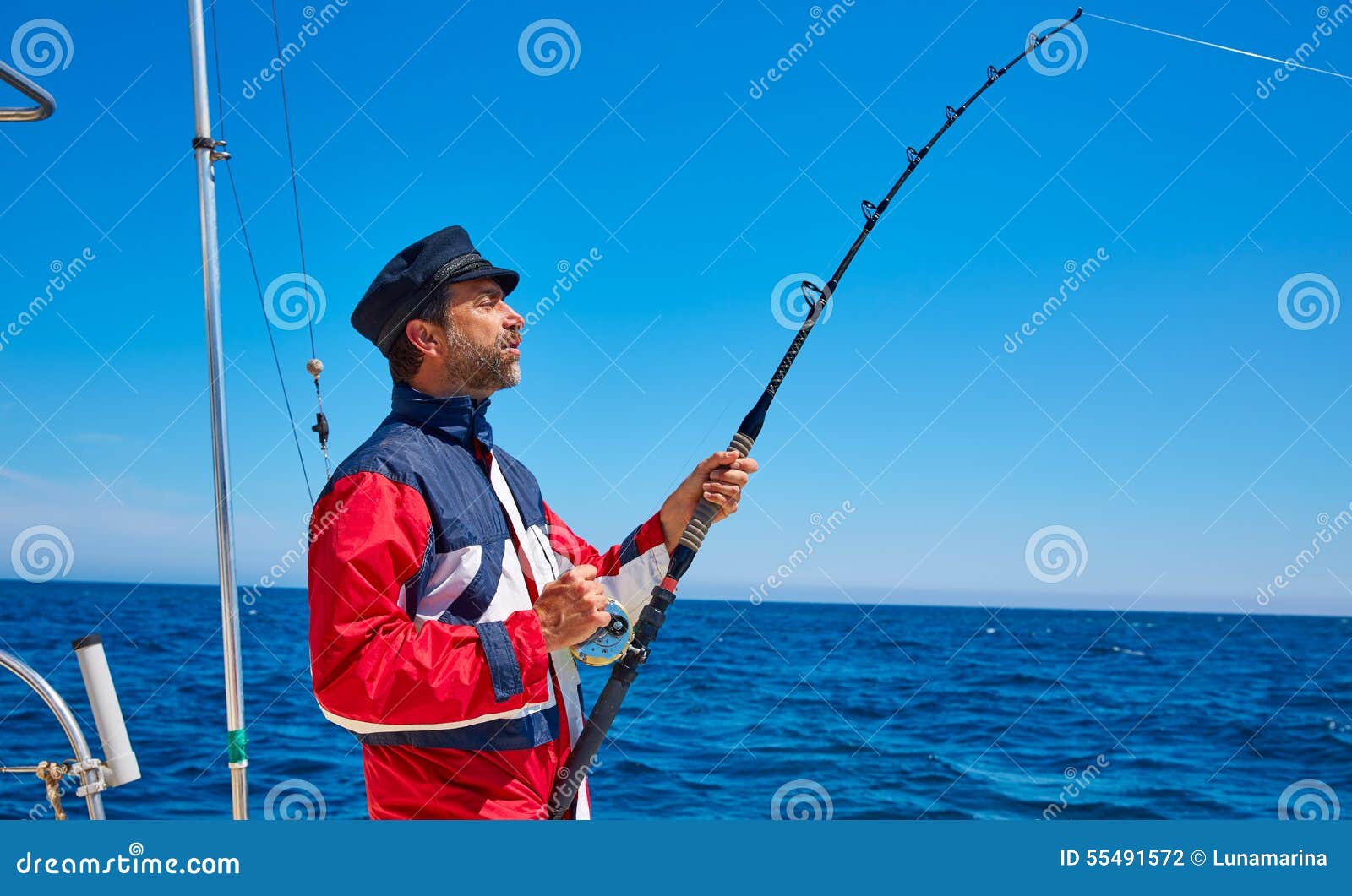 Beard Sailor Man Fishing Rod Trolling in Saltwater Stock Photo
