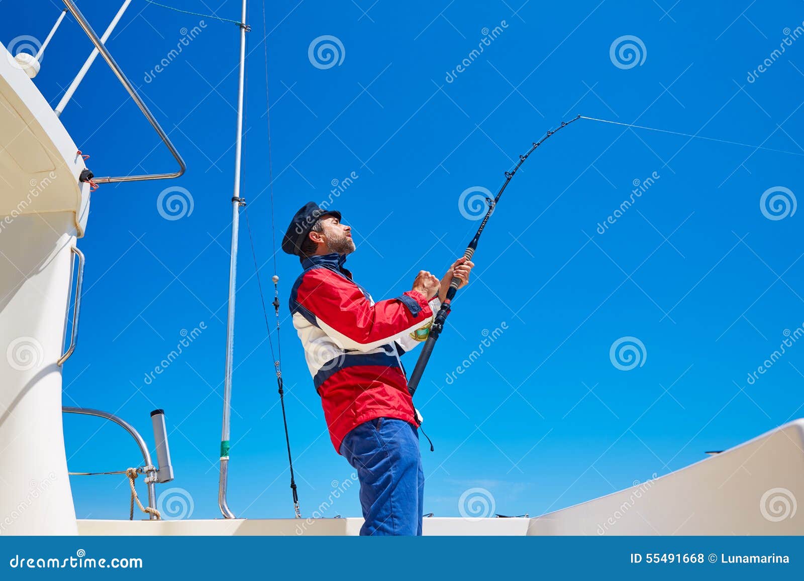 Beard Sailor Man Fishing Rod Trolling in Saltwater Stock Photo