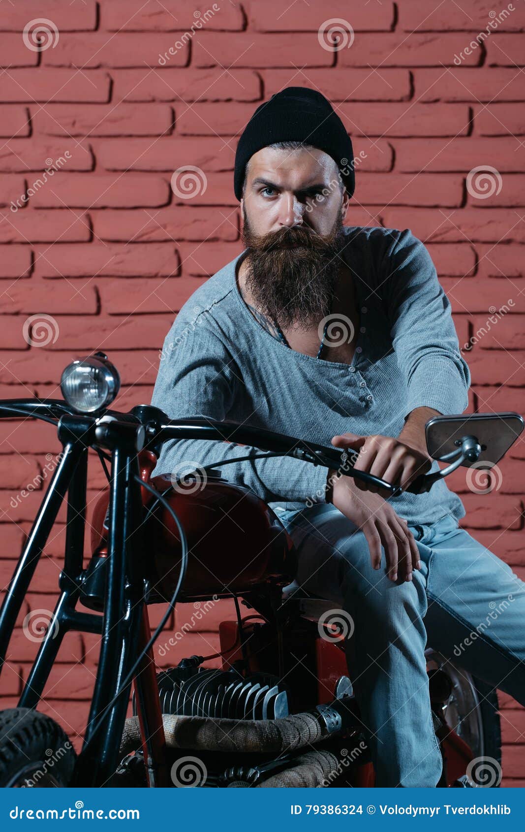 Bearded Biker Man On Motorbike Stock Photo - Image of wall, rider: 79386324