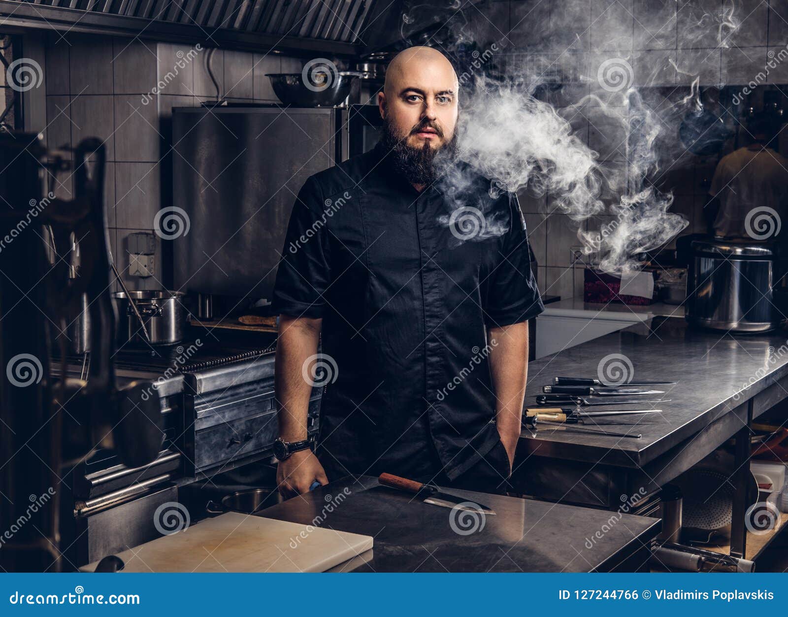 Bearded Chef in Black Uniform Smoking E-cigarette while Standing in the ...