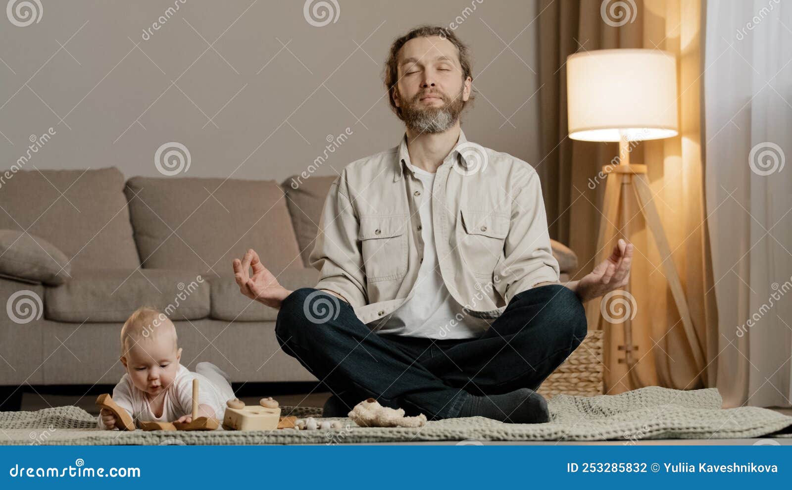 bearded father dad man parent sitting floor lotus position meditating stress relief meditation rest little daughter infant 253285832