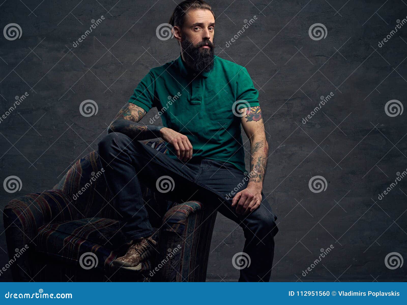 Tattooed Bearded Male Sits on a Chair. Stock Photo - Image of arms ...