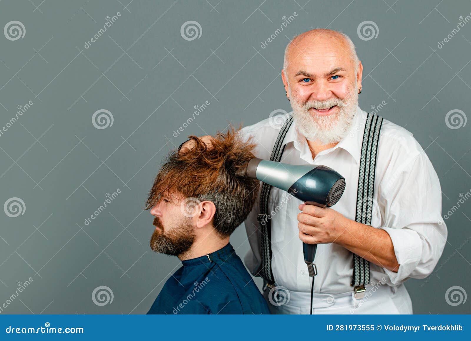 Bearded Man Getting Hairstyle by Hairdresser with Hair Dryer at Barbershop photo picture