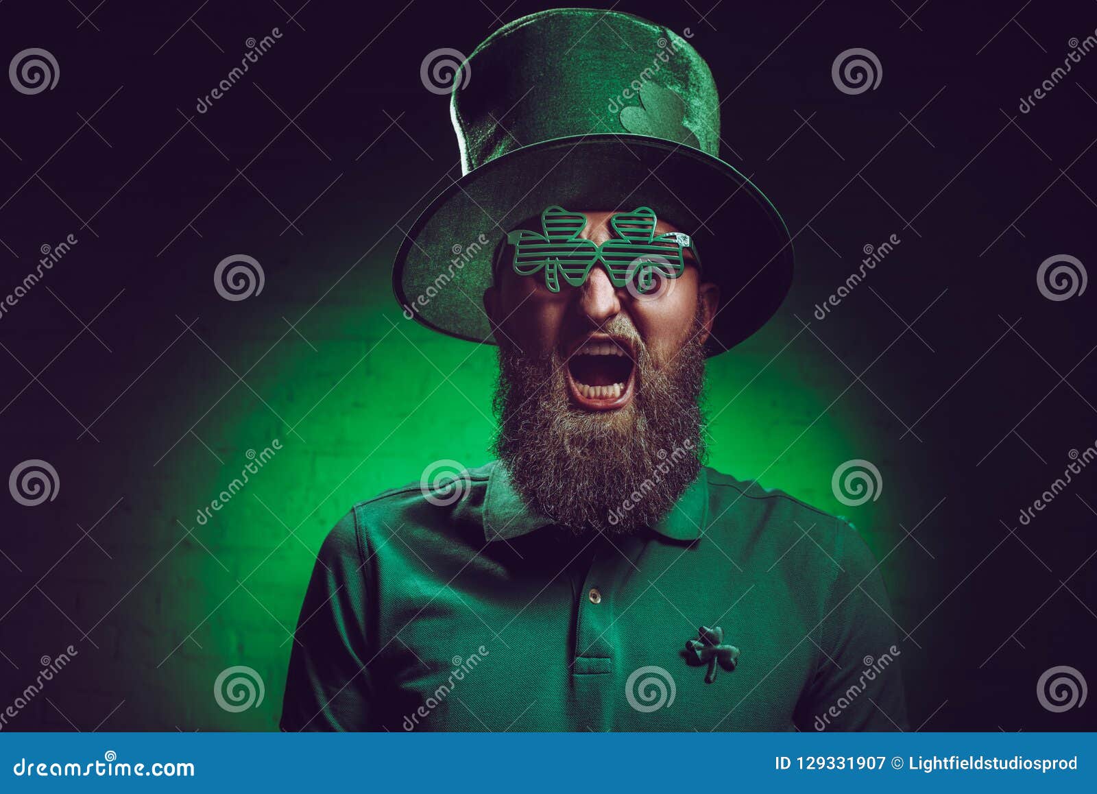 bearded man in green irish hat and funny eyeglasses screaming