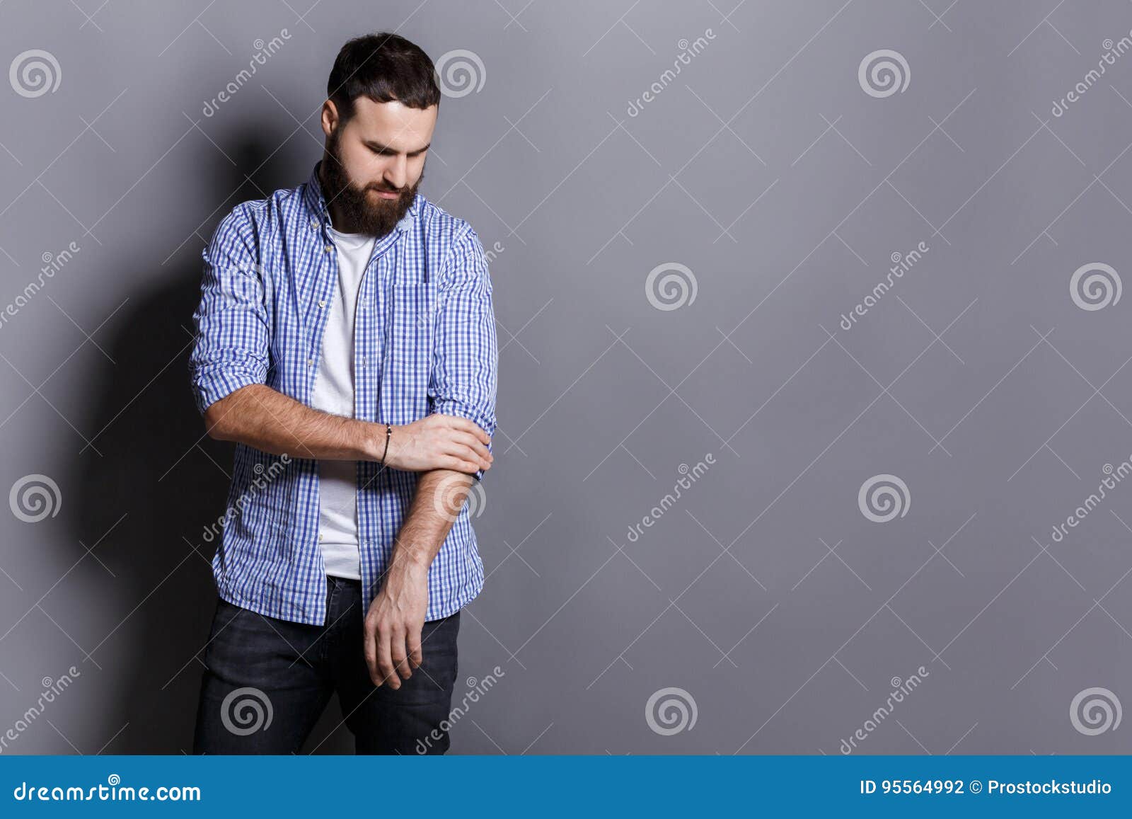 Bearded Man in Shirt Adjusting Sleeves Copy Space Stock Photo Image