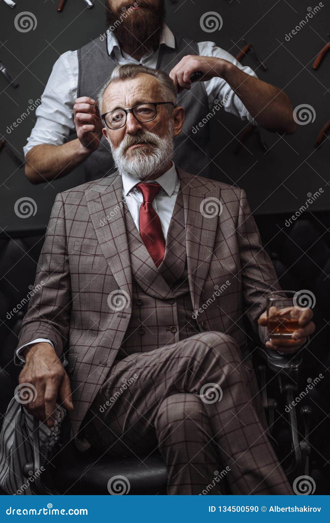 Bearded Old Businessman Sitting At Barber Shop In Chair Choosing
