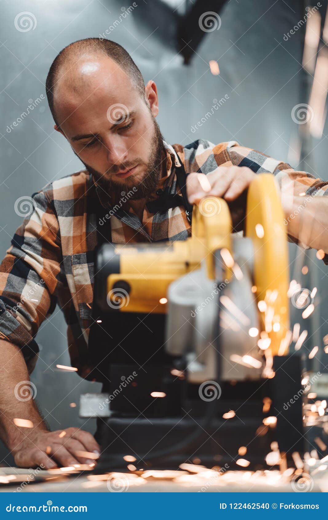 Bearded Worker Mechanic Using Electrical Angular Grinding Machine in