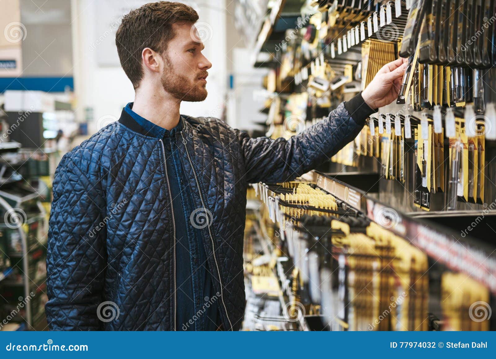bearded young man in a hardware store