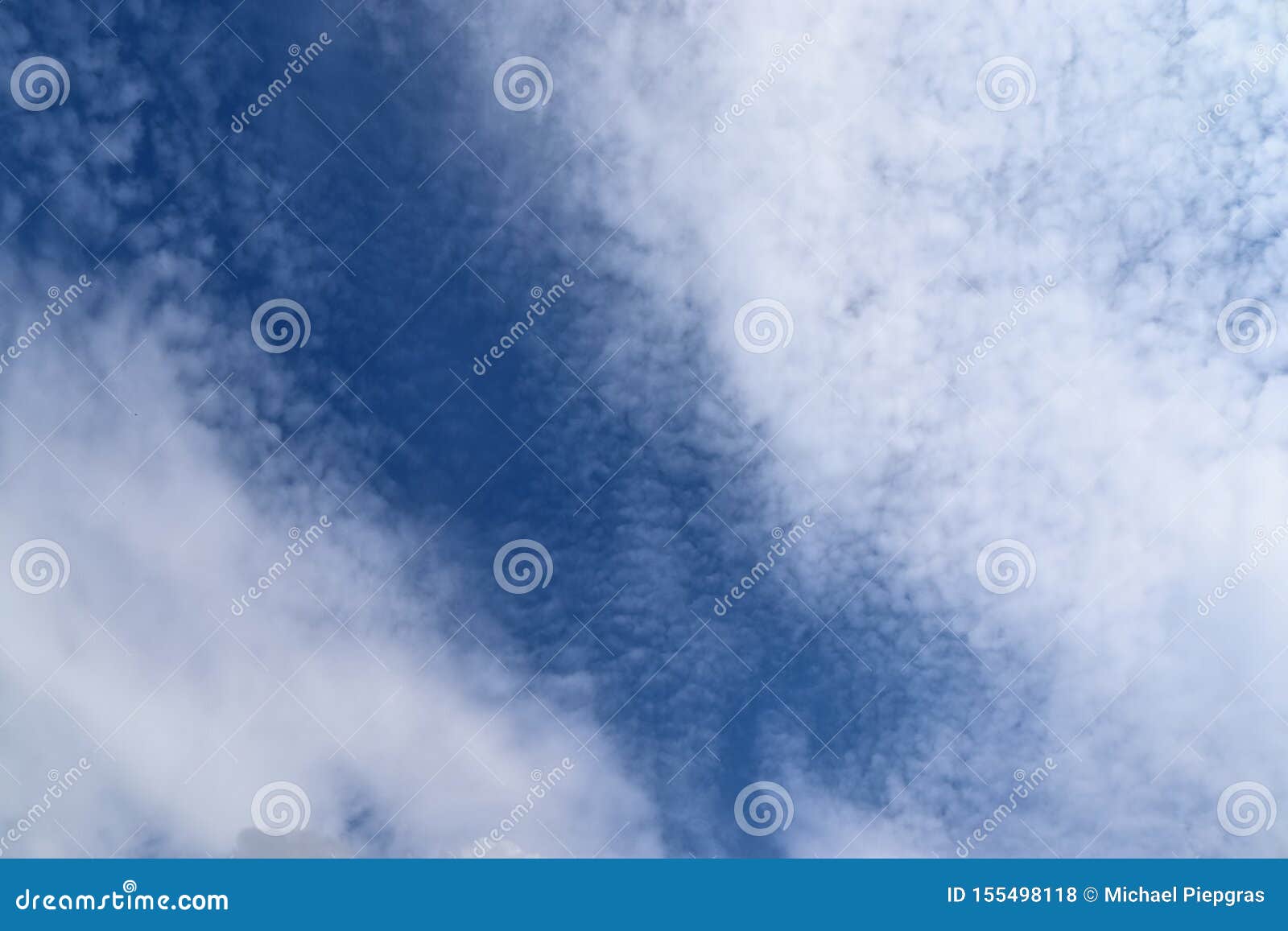 beaufitul fluffy white clouds on a deep blue summer sky