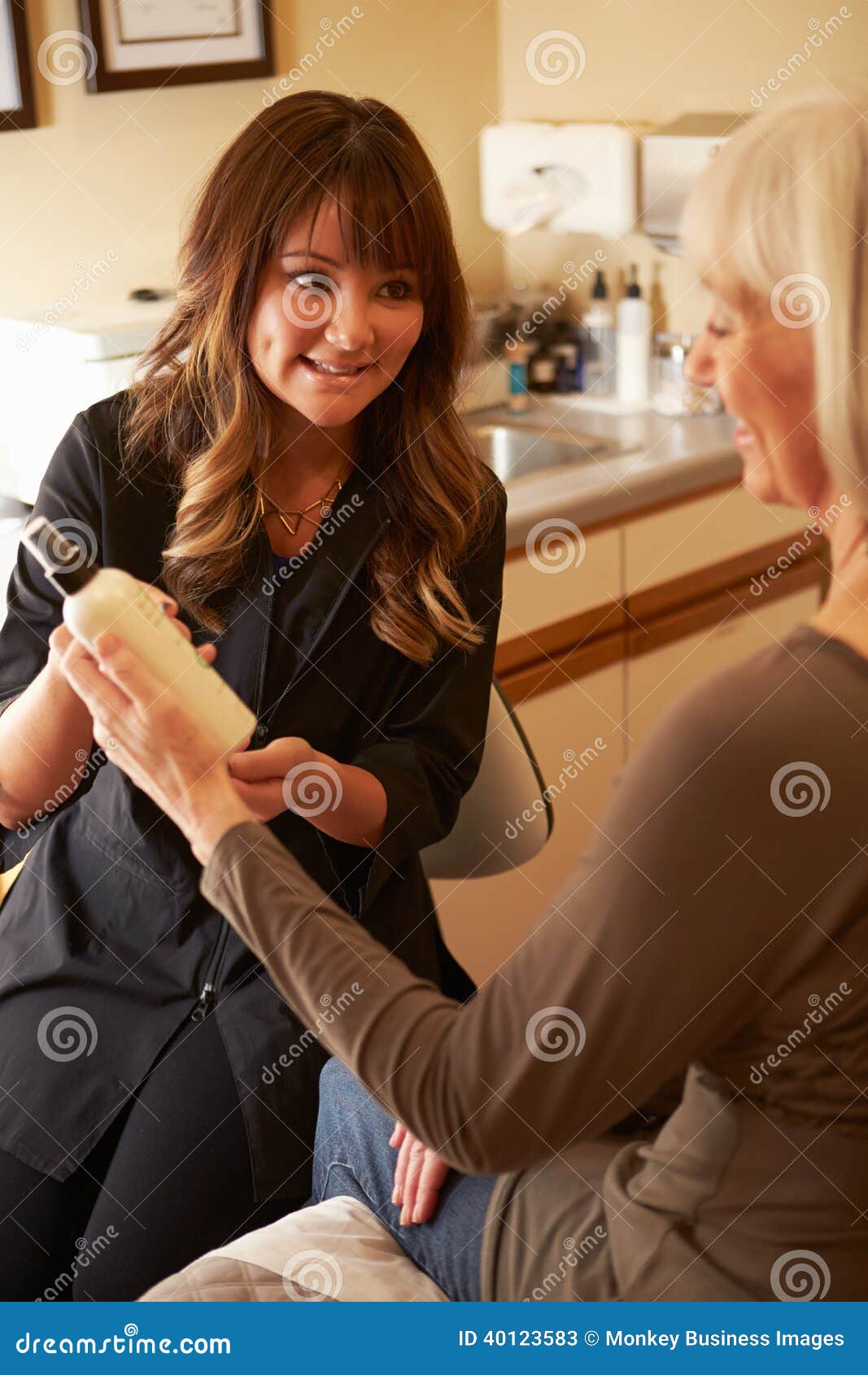 beautician advising female client on beauty products