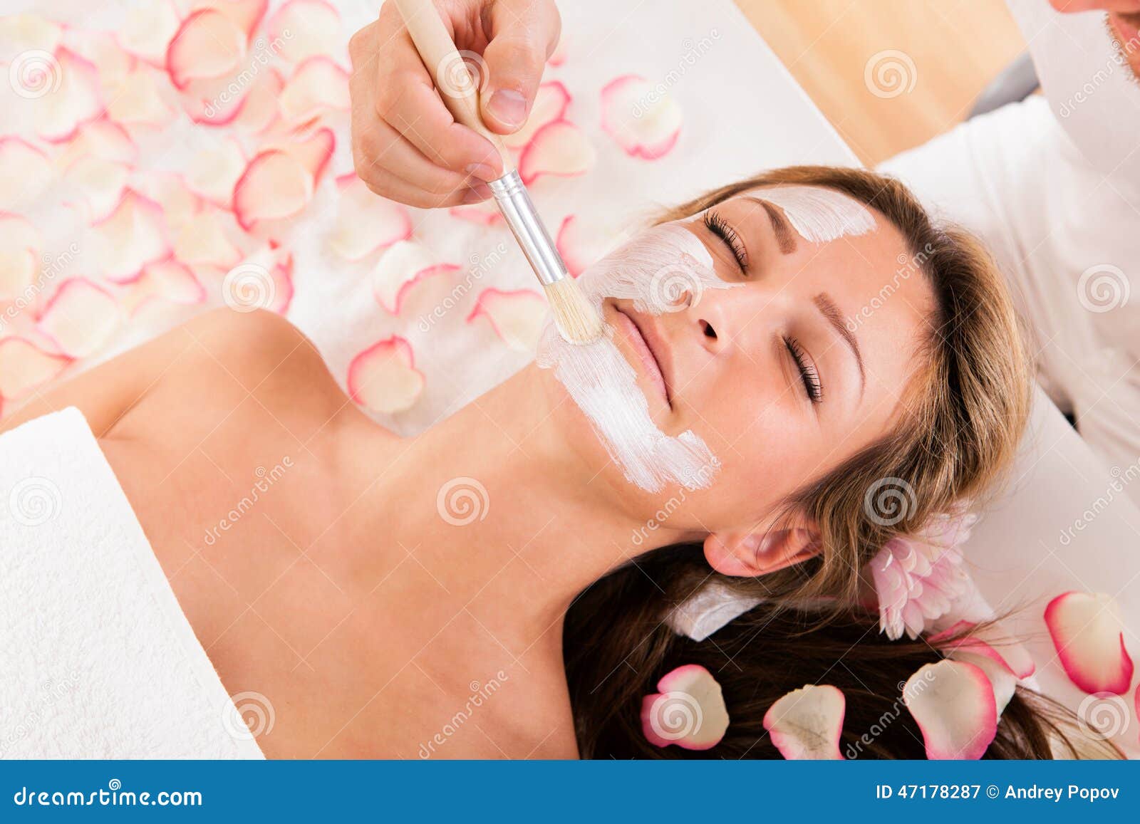 beautician applying a face mask