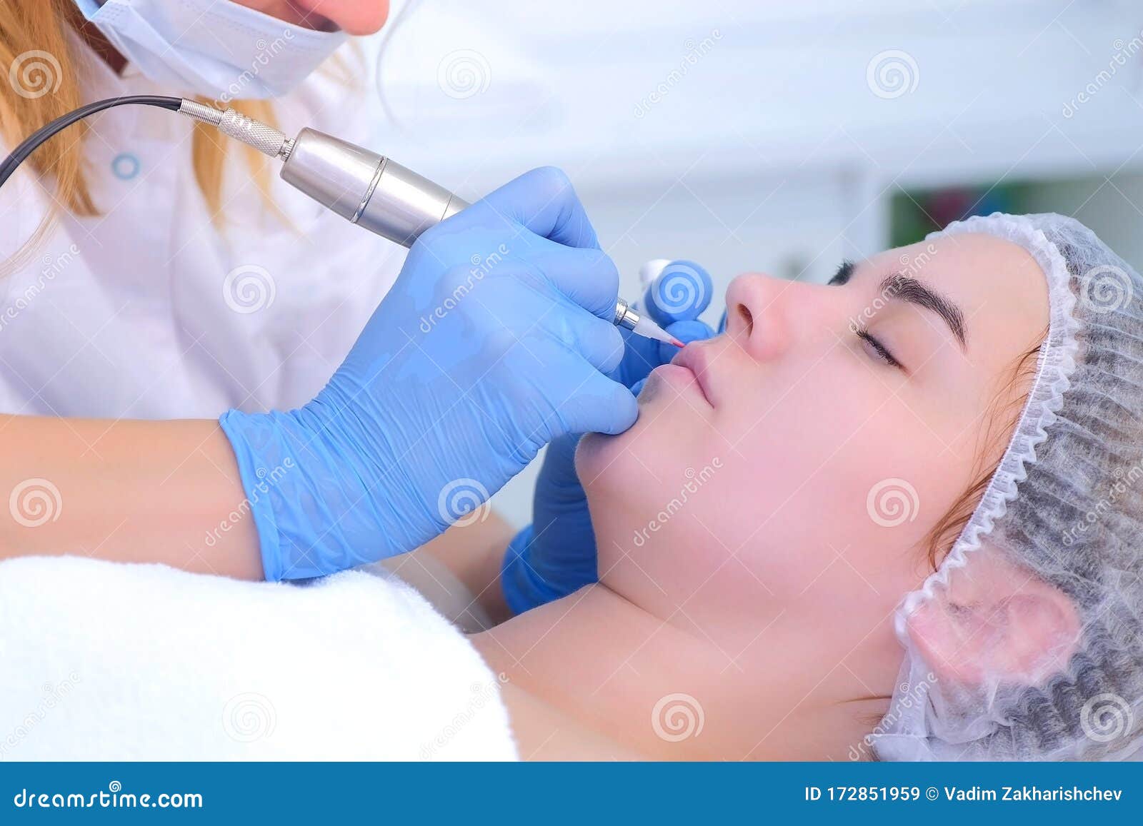 Beautician Applying Permanent Makeup on Lips Makes Contour Using Tattoo