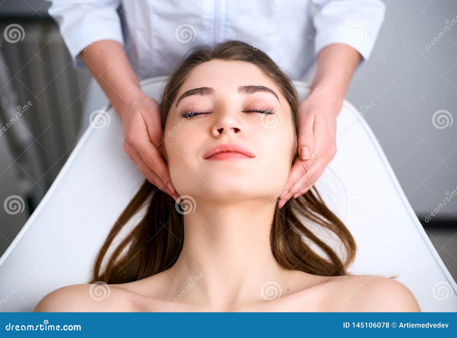 beautician cleaning woman`s face. spa skincare treatment. cosmetologist with patient on medical chair. healthy skin