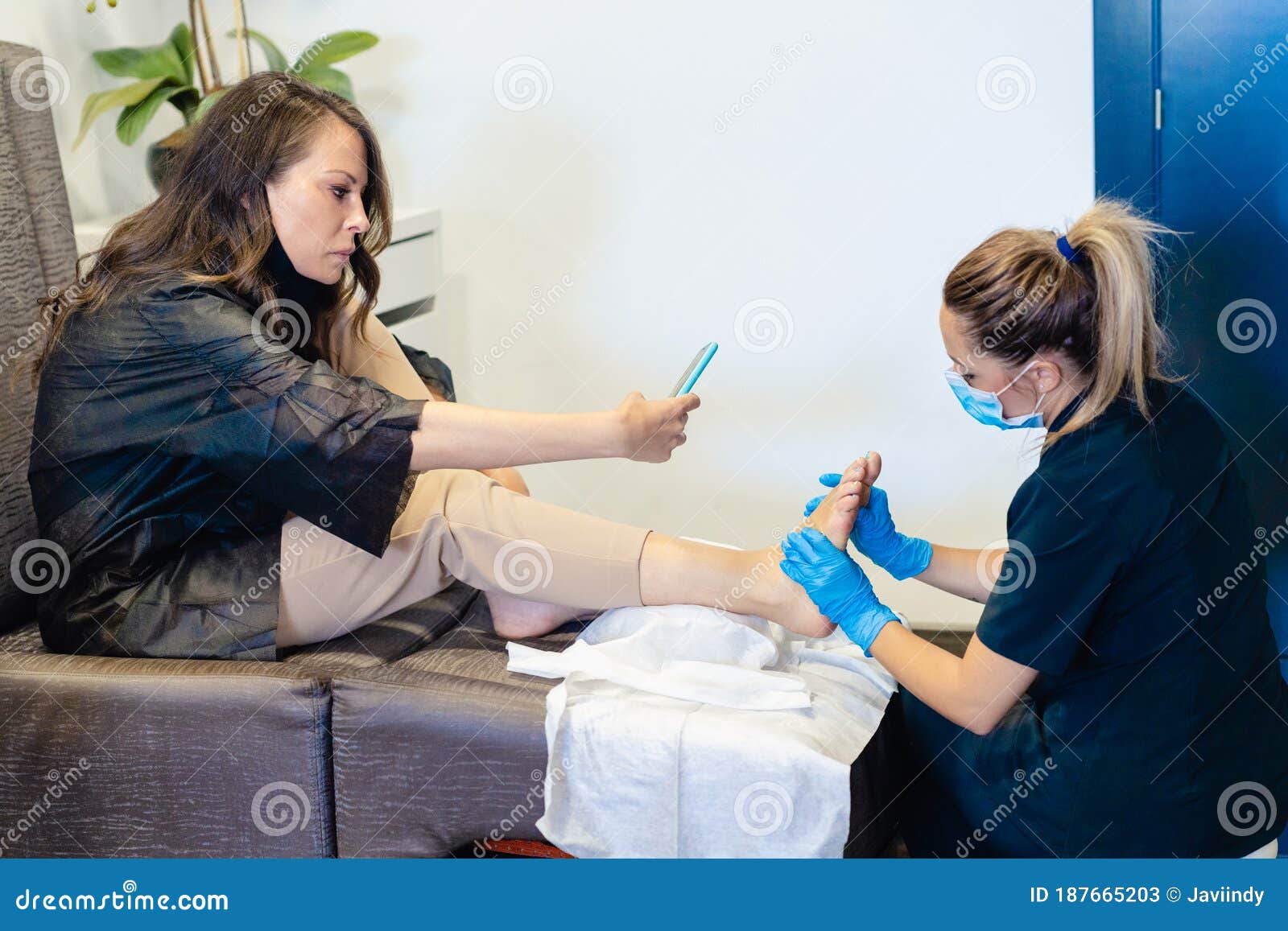 Beautician Giving a Pedicure Painting Her Client`s Nails in a Beauty ...