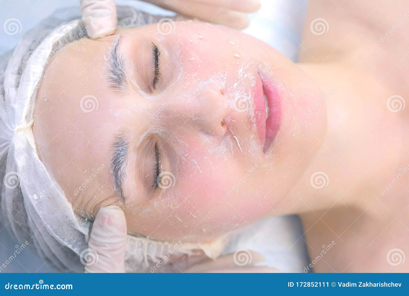 Cosmetologist Making Facial Massage With Peeling Mask On Woman`s Face Closeup Stock Image