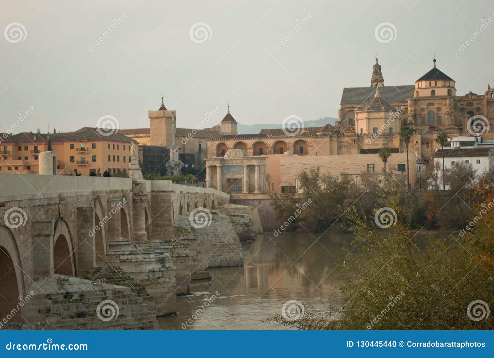 the beautiful roman bridge over the river guadalquivir leading to the town of cordoba in andalusia