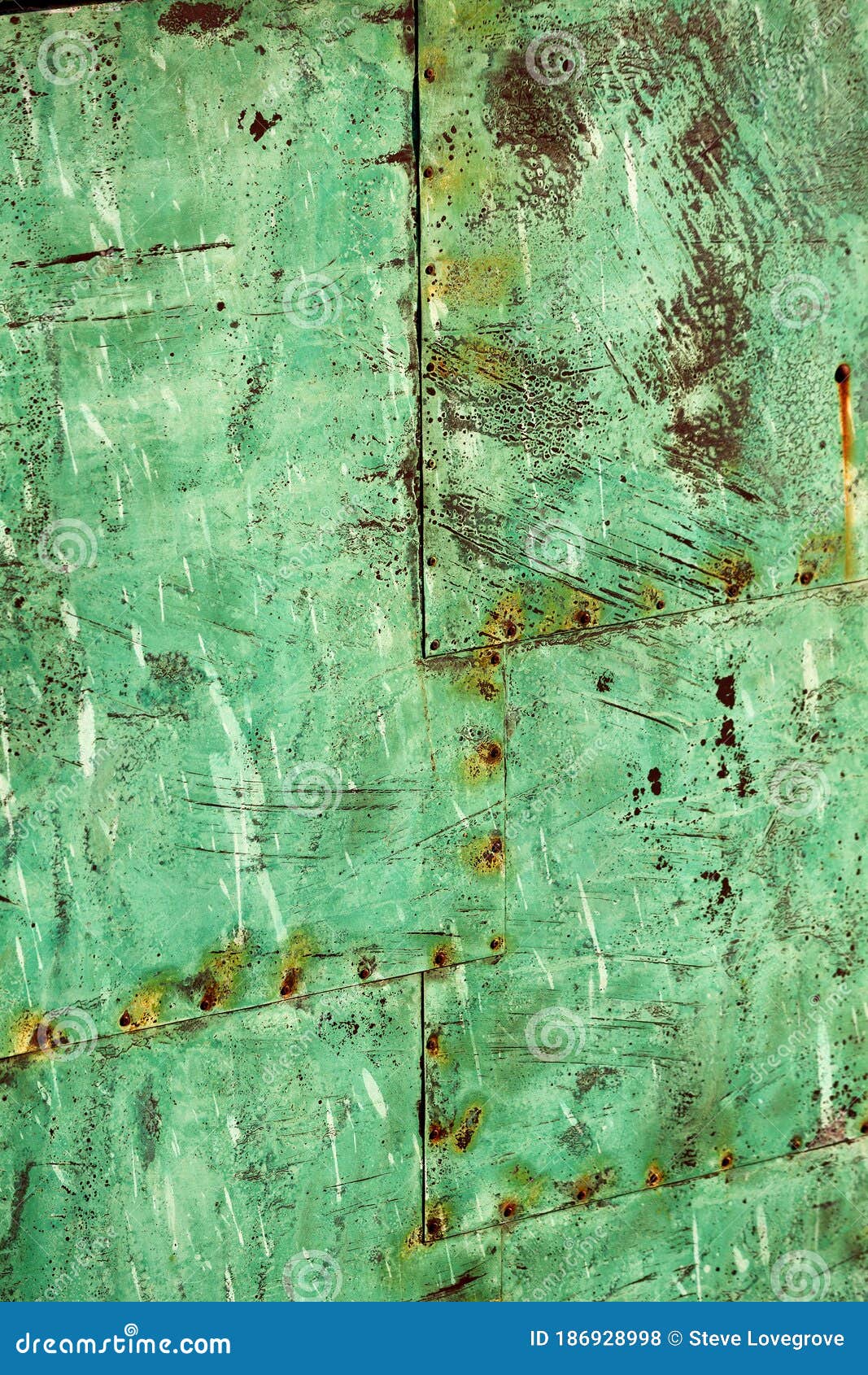 beautiful abstract patterns and texture of rivted panels of exposed copper sheet with green aged patina