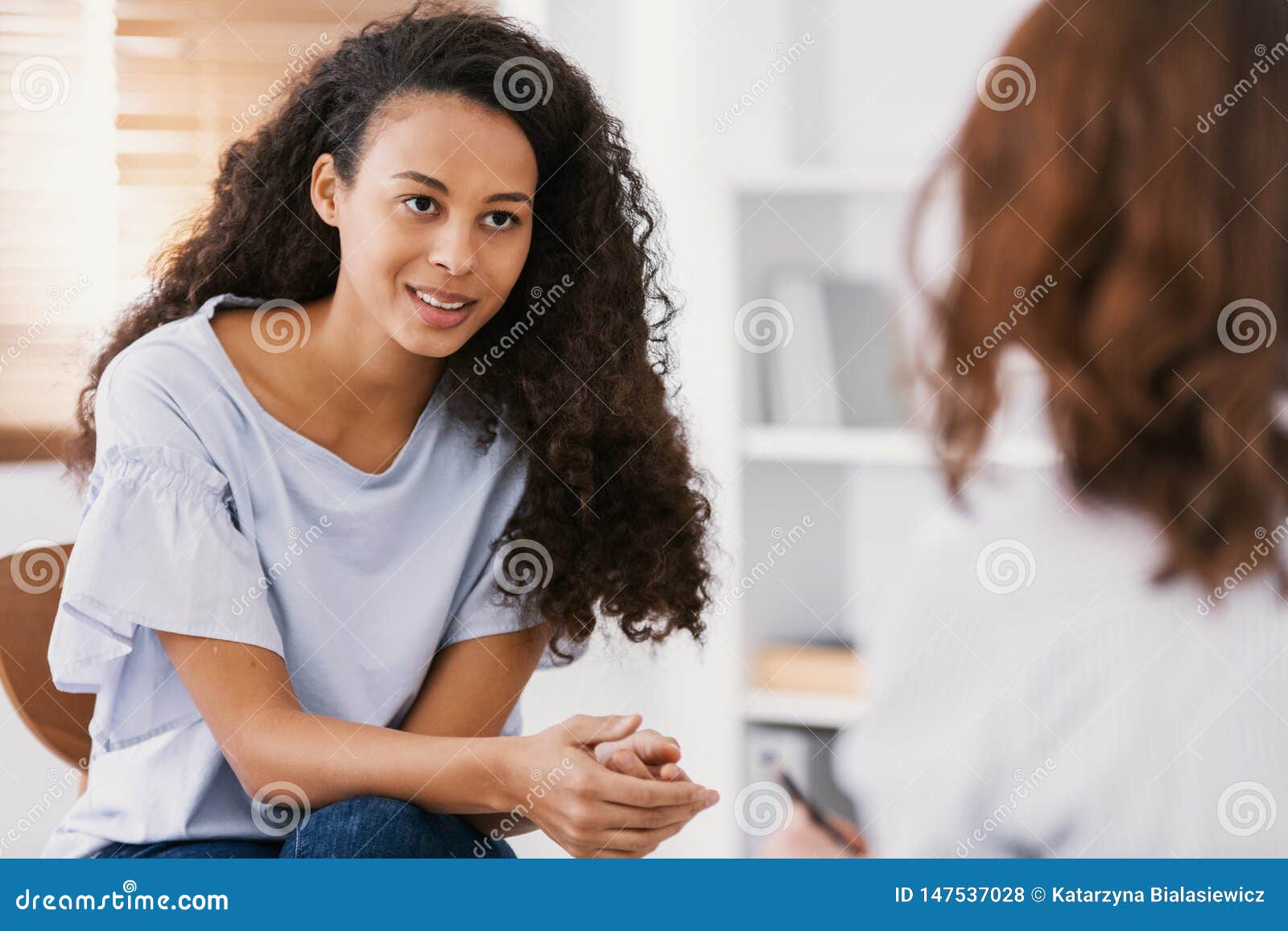 beautiful african american girl during meeting with professional counselor