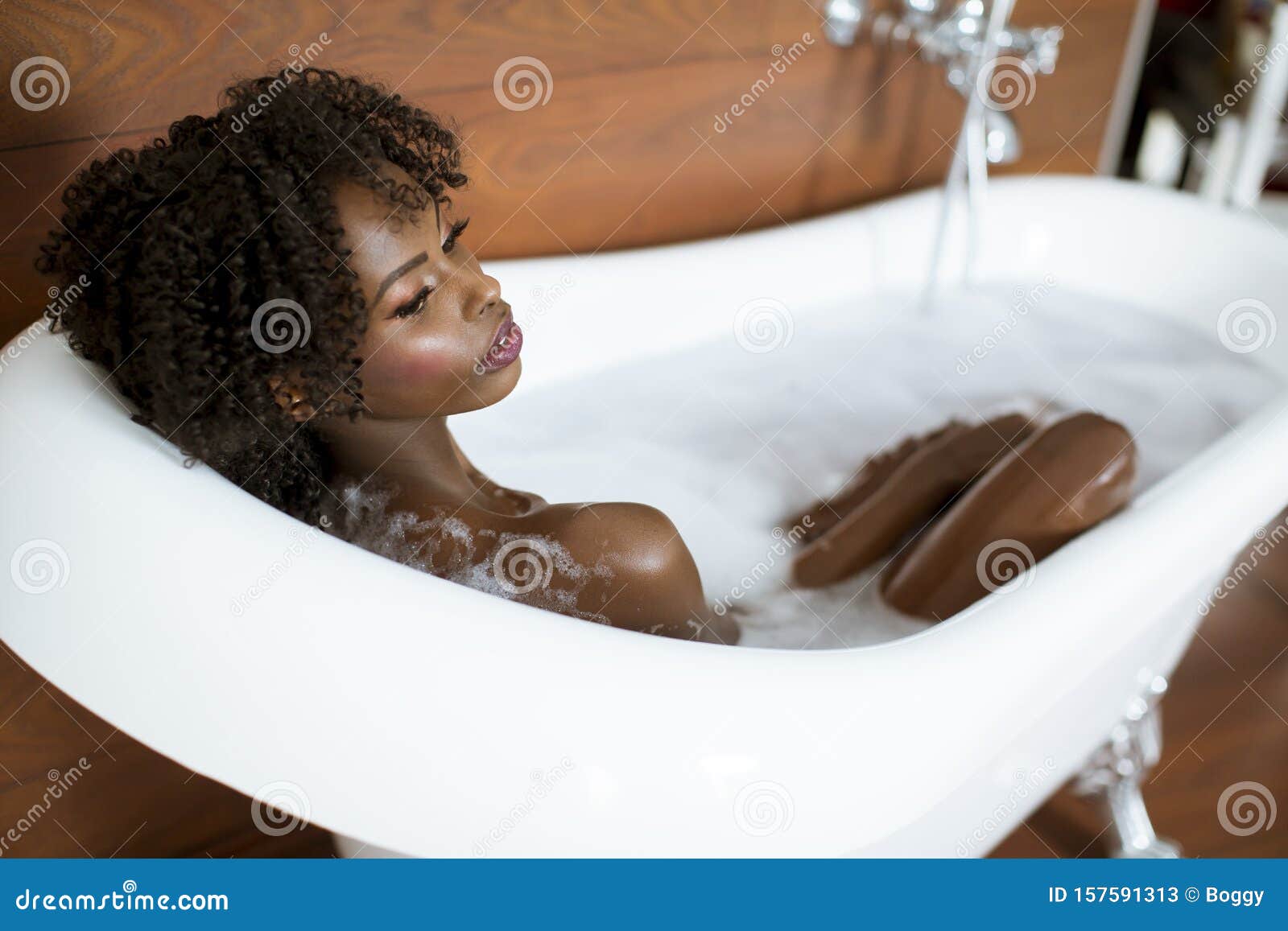 Beautiful African American Woman Bathing In A Tub Full Of