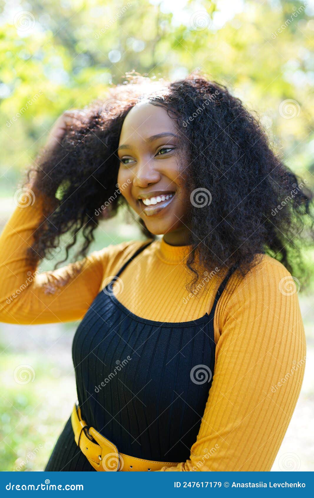 Beautiful African American Woman Smiling And Walking In The Park During Sunset Outdoor Portrait