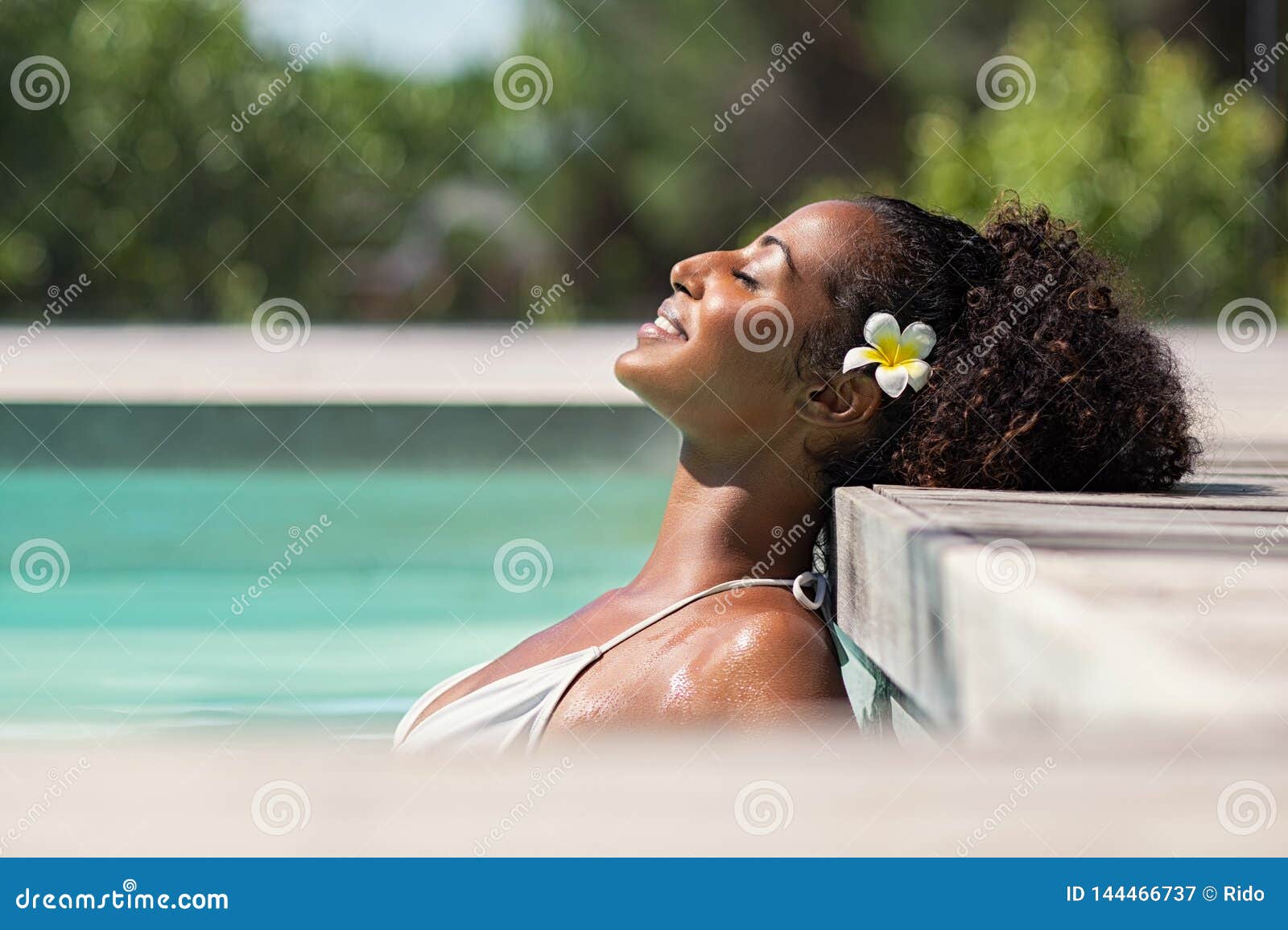 beautiful african woman in pool relaxing