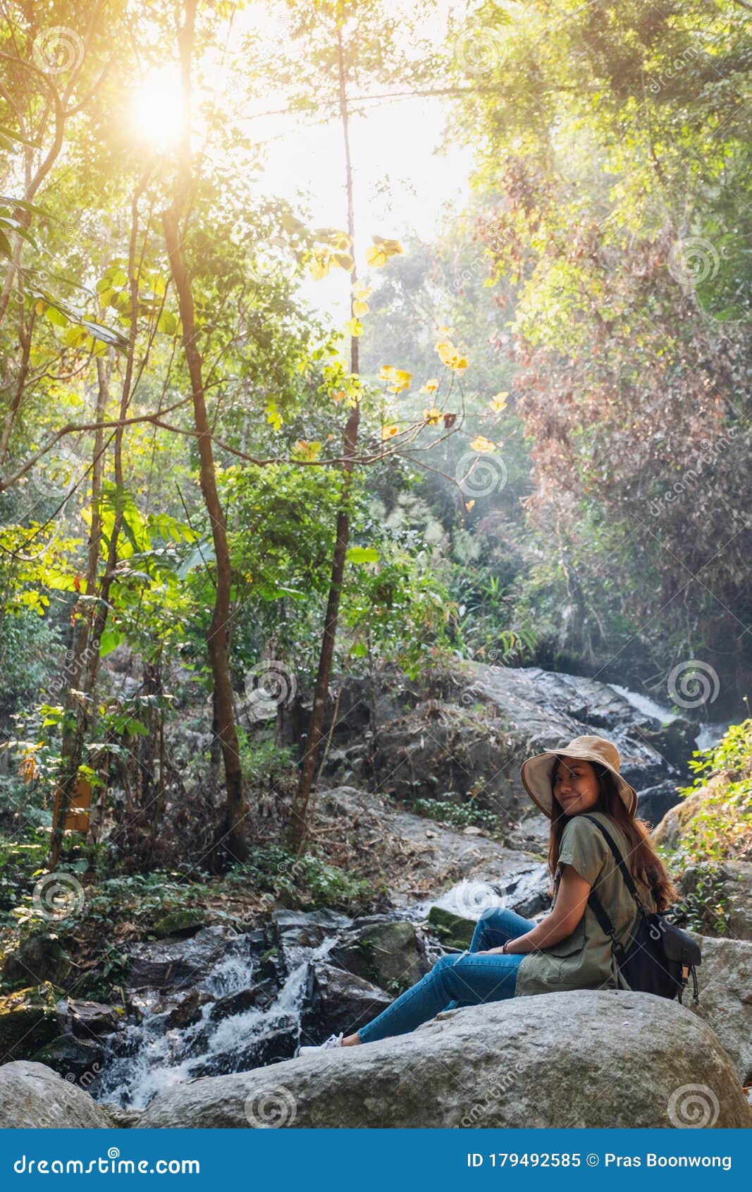 A Woman Sitting on the Rock in Front of Waterfall Stock Image - Image ...
