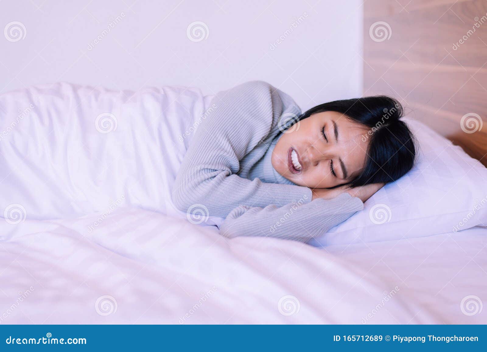 beautiful asian woman sleeping on bed and grinding teeth,female tiredness and stress