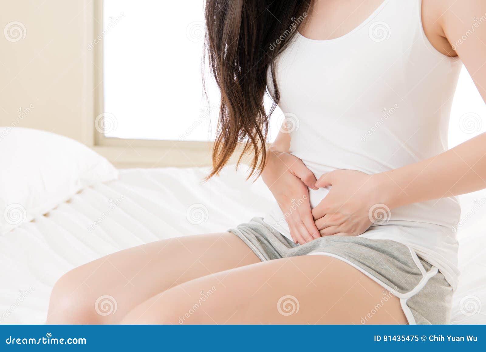 beautiful asian woman suffering from stomach physiological period pain