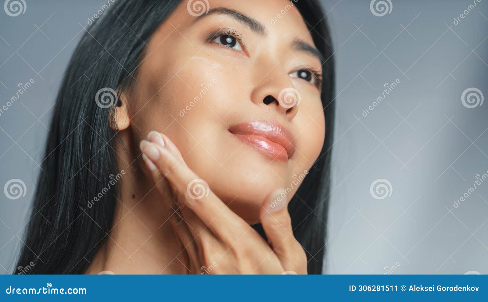 beautiful asian woman touches her perfect face. female enjoying her beauty, high self esteem and w