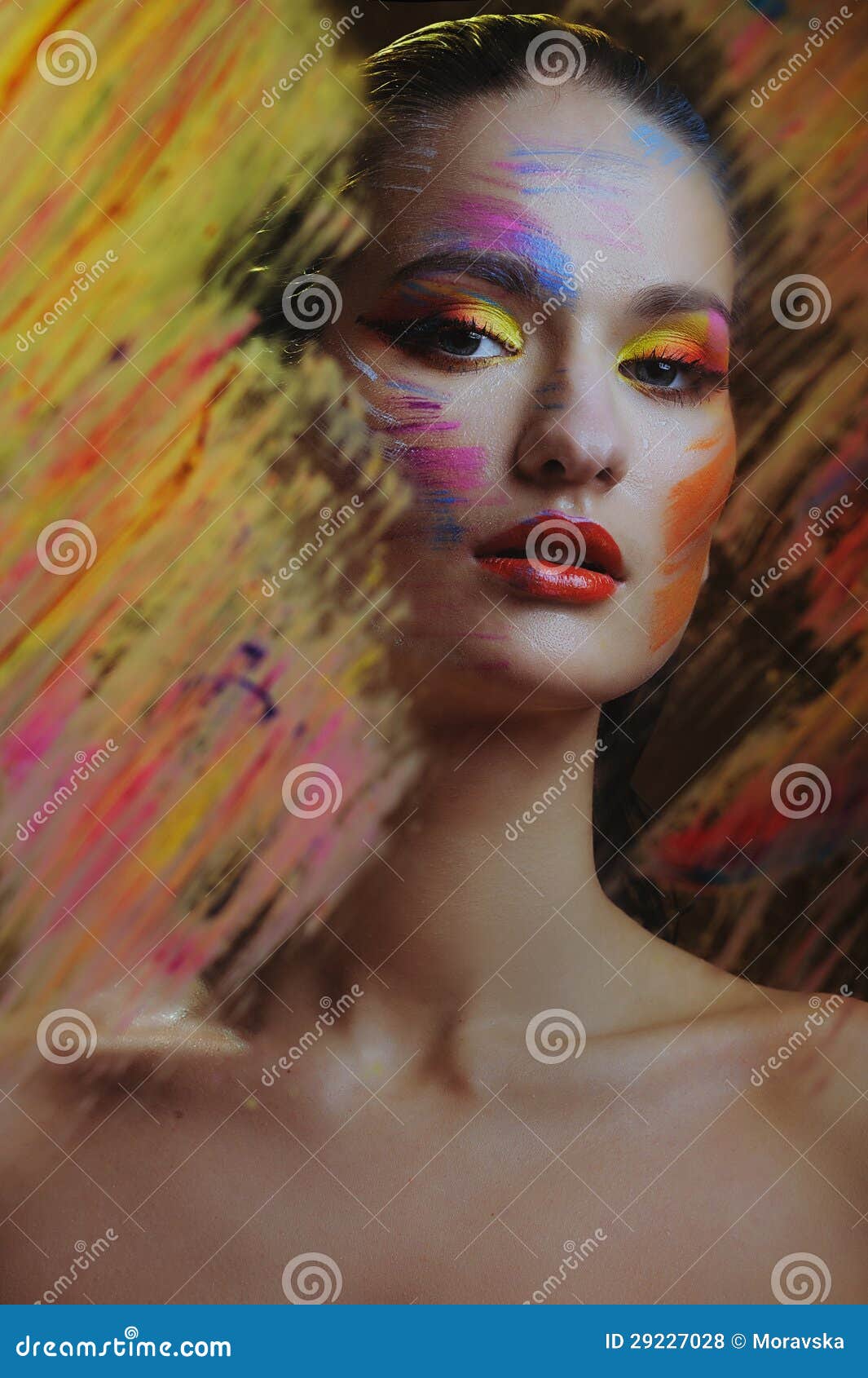 beautiful attractive woman in color paint splash behind the painted color glass