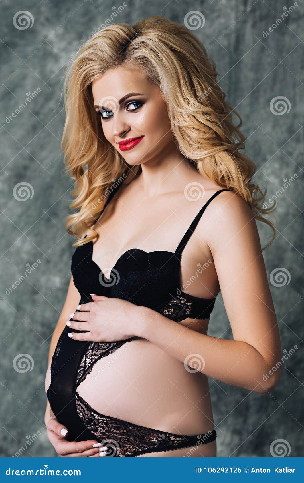 Beautiful Attractive Woman is Pregnant, Pregnant White Woman with Long Blond Curly Hair in Black Underwear, Beauty of Stock Photo picture