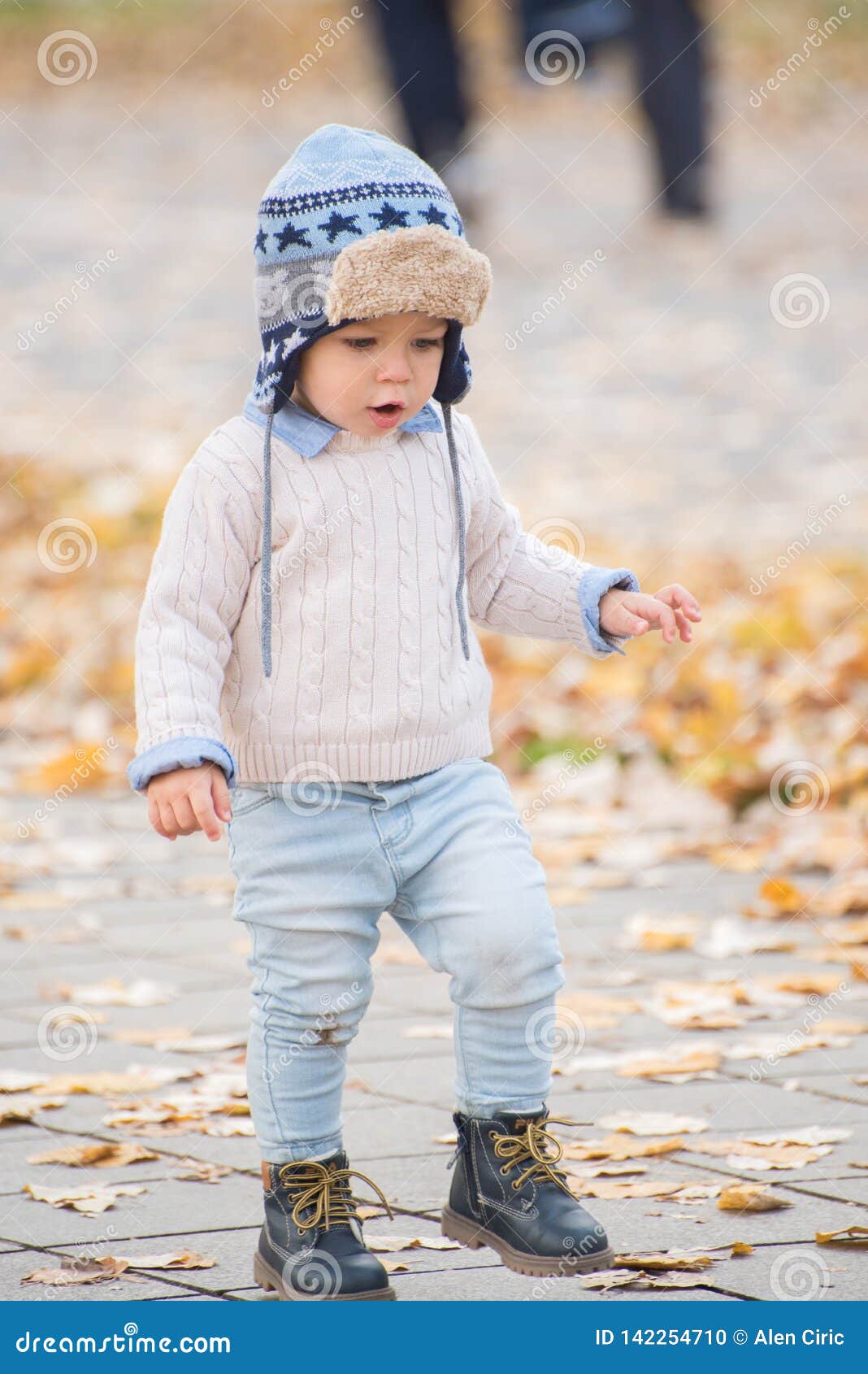 Beautiful Baby Boy Walking Throw The Autumn Leaves At The Park Stock