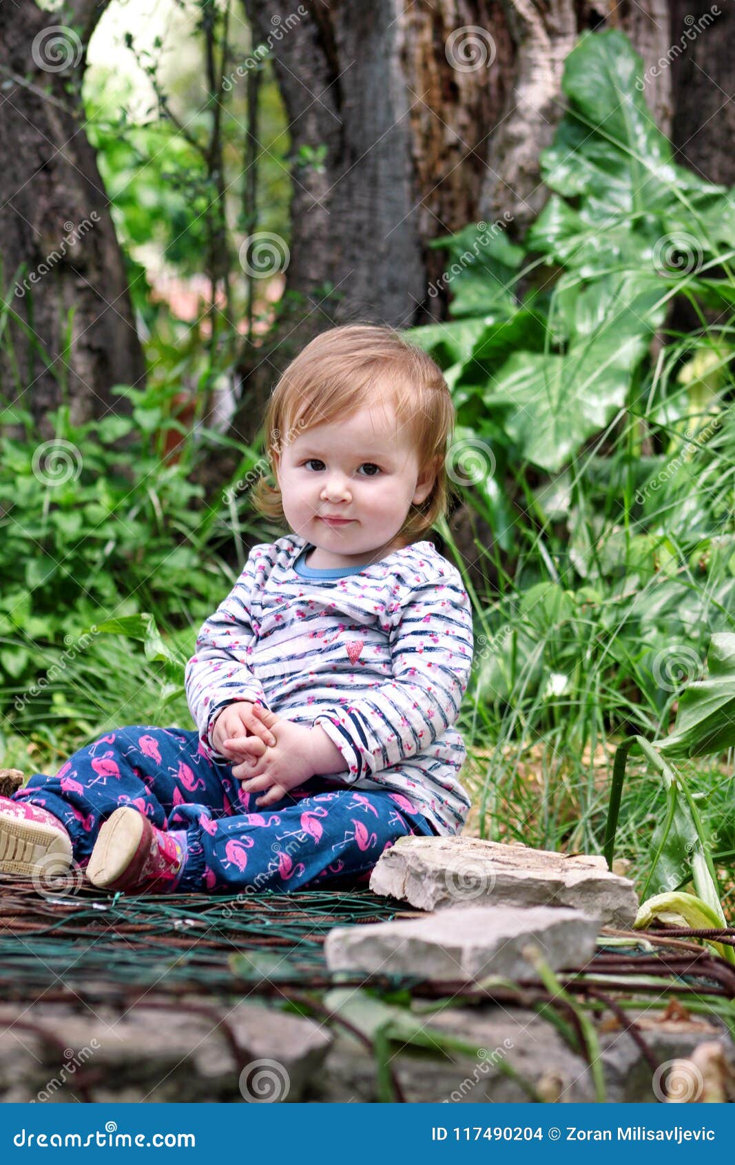 Download Beautiful Baby Sitting, Smiling And Posing, Portrait. Little Cute Girl Is Playful In Garden ...