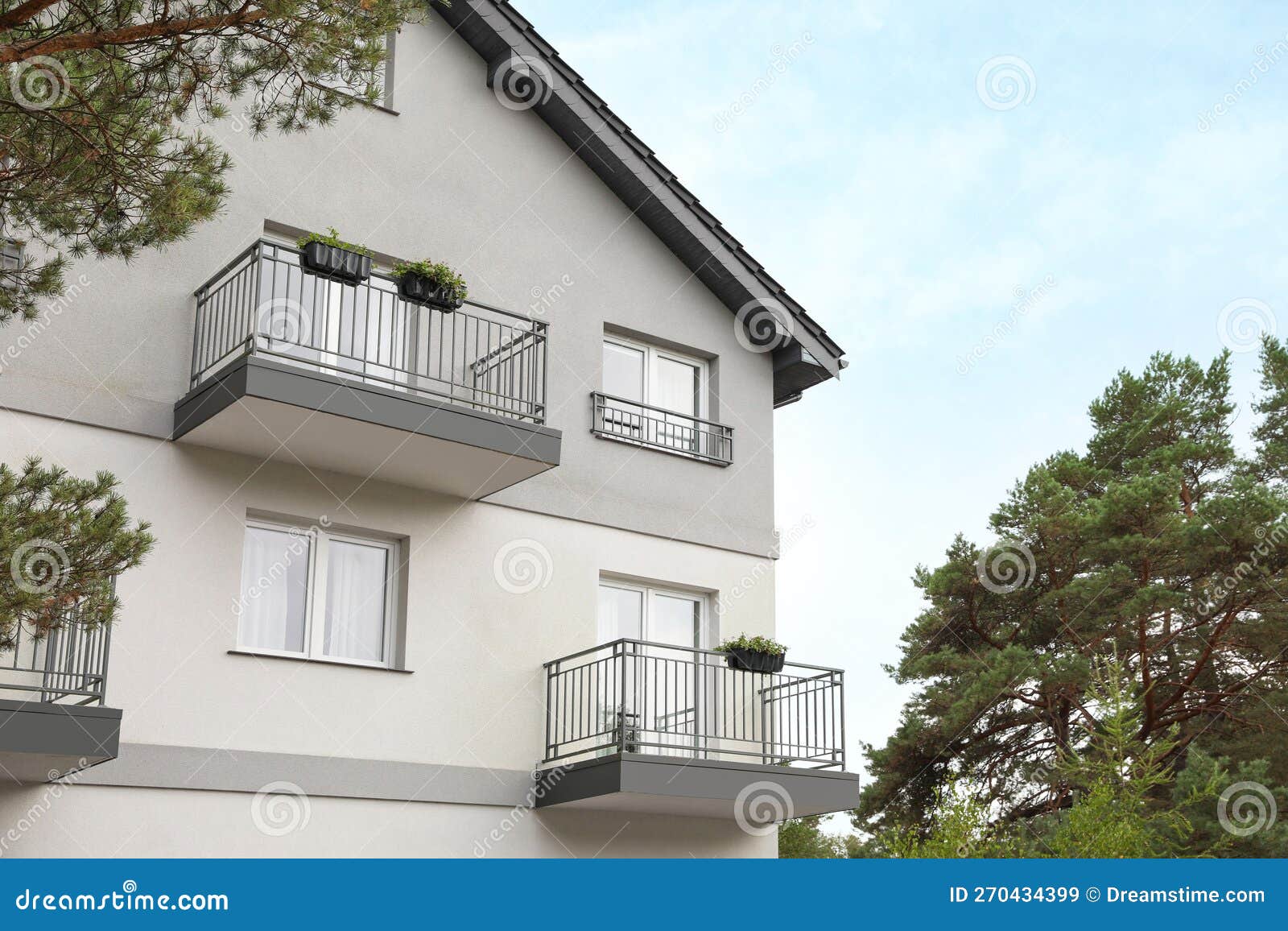 Beautiful Beach House with Balconies and Trees Outdoors Stock Image