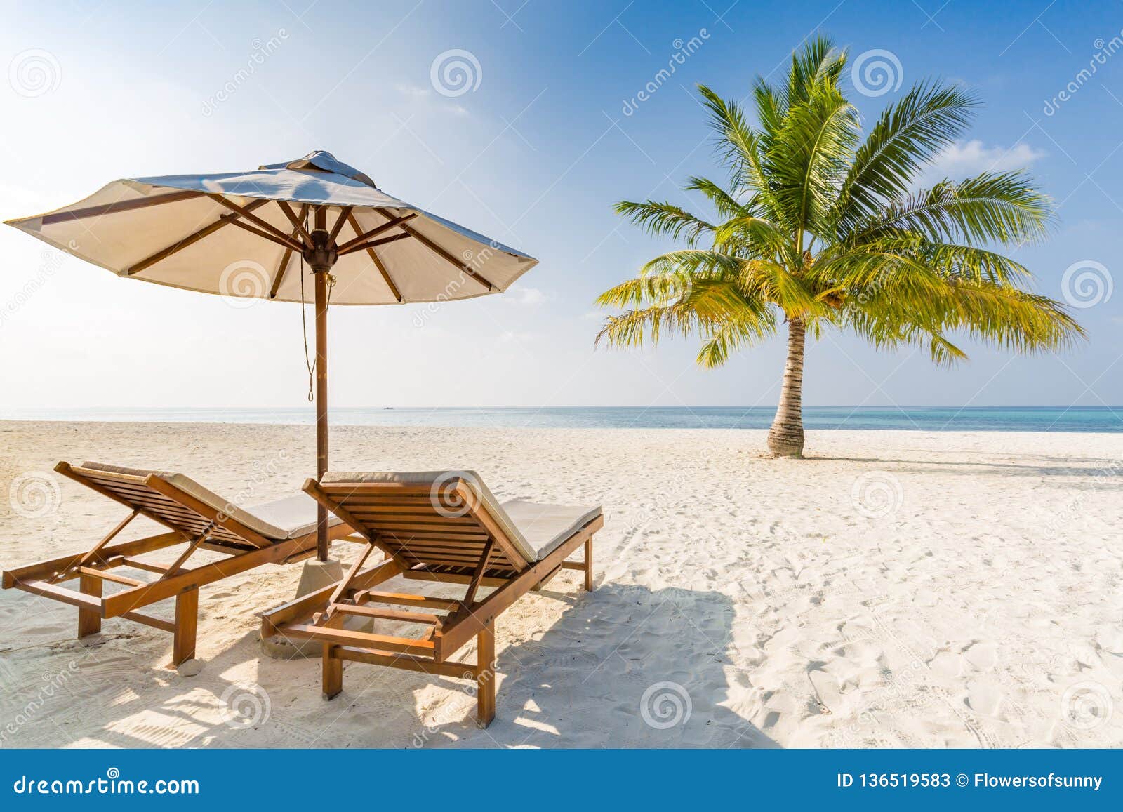 idyllic beach landscape, two sun chairs and umbrella