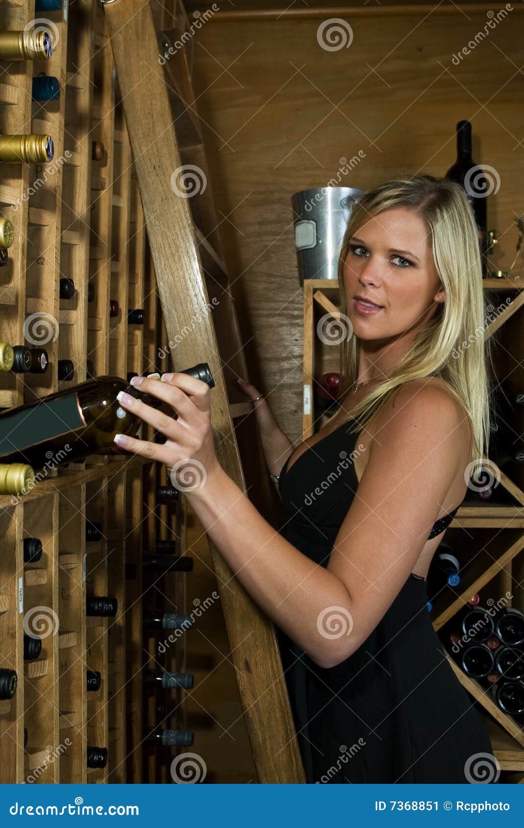 Beautiful Blond Picking a Bottle of Wine Stock Image Image of