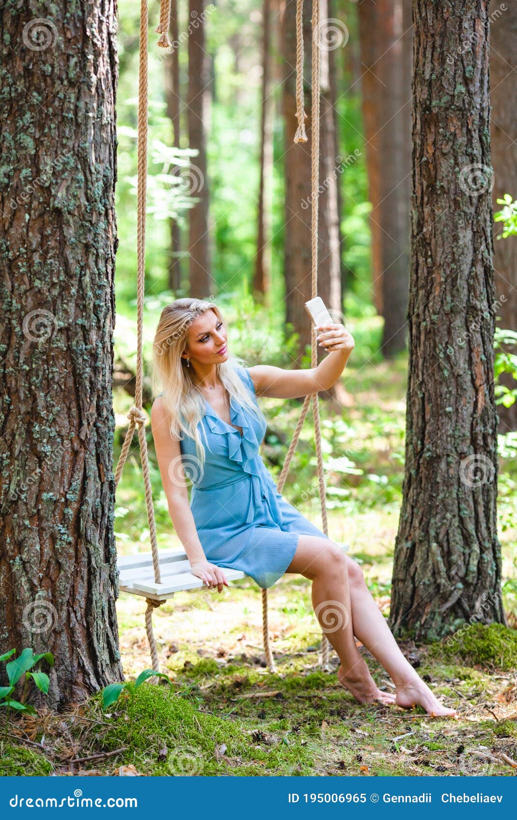 https://thumbs.dreamstime.com/z/beautiful-blond-woman-blue-dress-using-smartphone-to-taking-selfie-swing-background-summer-forest-beautiful-195006965.jpg