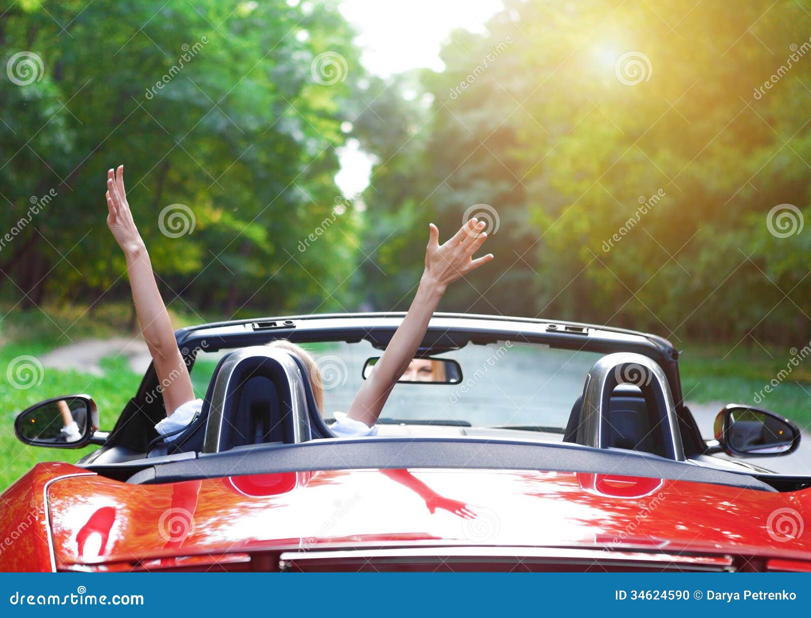 beautiful blond young woman driving a sports car