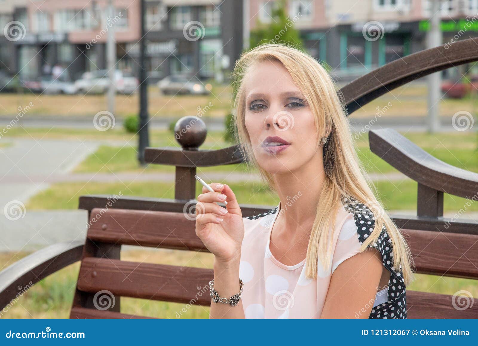 Beautiful blonde smoking outdoor