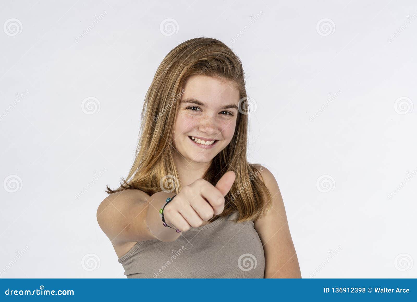 Cute teen blond girl gives attitude and looking to camera 