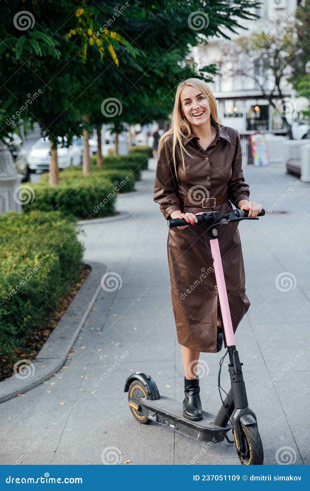 Woman in a Raincoat on an Electric Scooter Street of the City Stock ...